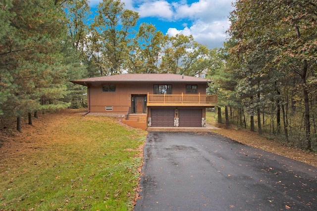 1167 Tee Trl, Nekoosa, WI 54457 - view of front of property featuring driveway, an attached garage, a front yard, and stone siding