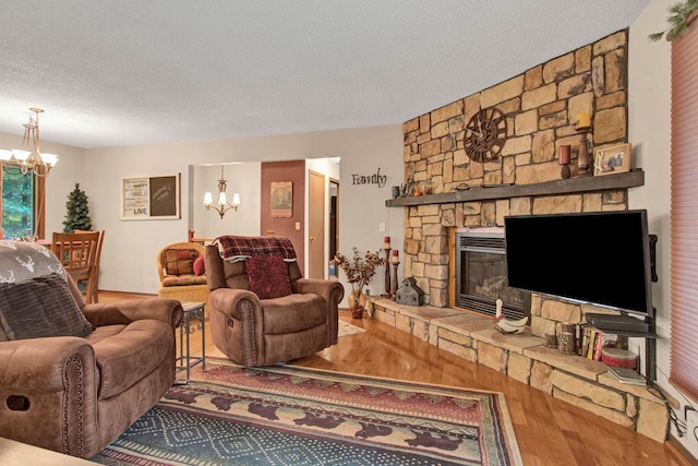 1167 Tee Trl, Nekoosa, WI 54457 - living area with a chandelier, wood finished floors, and a stone fireplace