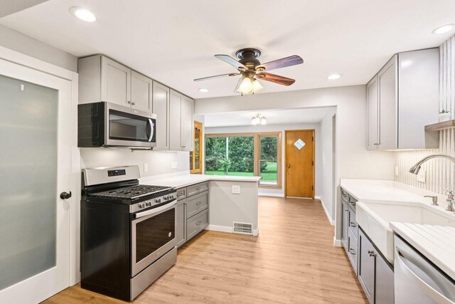 W262S3159 View Dr, Waukesha, WI 53189 - kitchen with appliances with stainless steel finishes, gray cabinetry, ceiling fan, light countertops, and light wood-style floors