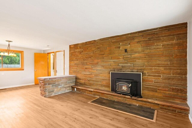 W262S3159 View Dr, Waukesha, WI 53189 - unfurnished living room featuring wood finished floors and a chandelier