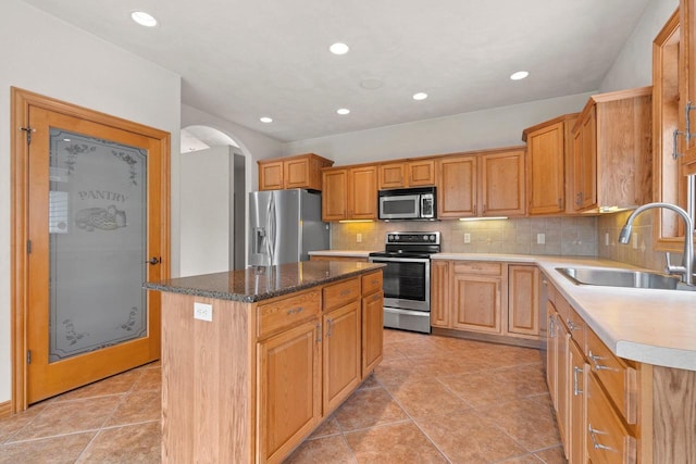 N3520 Range Ct, Freedom, WI 54913 - kitchen featuring appliances with stainless steel finishes, arched walkways, decorative backsplash, a kitchen island, and recessed lighting