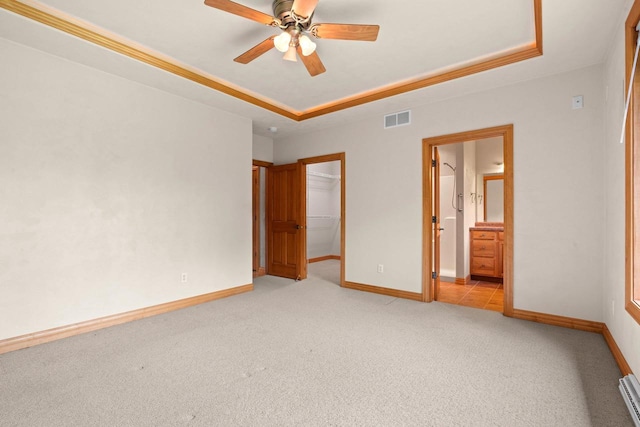 N3520 Range Ct, Freedom, WI 54913 - unfurnished bedroom with a tray ceiling, light colored carpet, a spacious closet, ensuite bathroom, and a closet