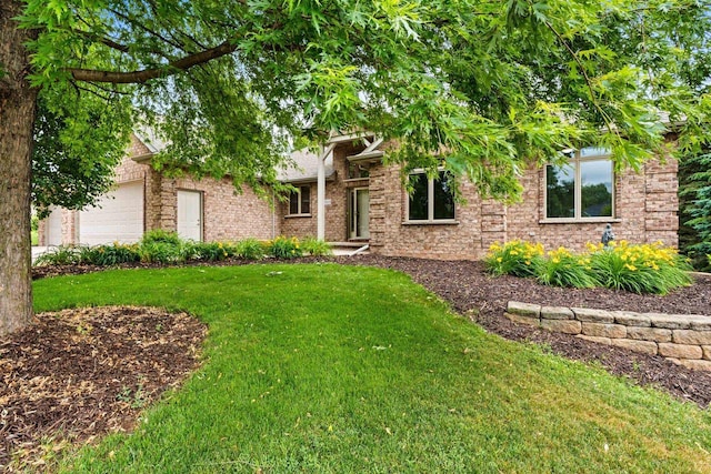 N3520 Range Ct, Freedom, WI 54913 - view of property hidden behind natural elements with a front lawn, a garage, and brick siding