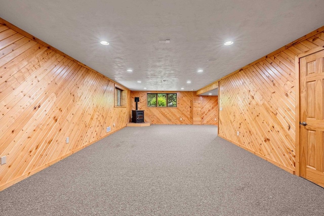 N3520 Range Ct, Freedom, WI 54913 - below grade area featuring wood walls, a wood stove, carpet flooring, and recessed lighting