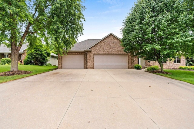 N3520 Range Ct, Freedom, WI 54913 - view of front of property with an attached garage, concrete driveway, a front yard, and brick siding