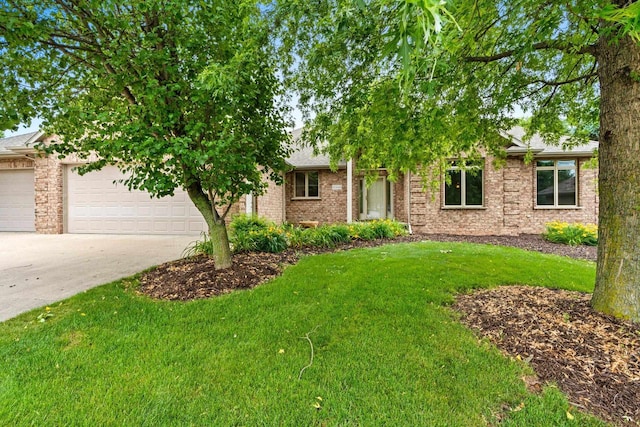 N3520 Range Ct, Freedom, WI 54913 - obstructed view of property featuring concrete driveway, a garage, a front lawn, brick siding, and roof with shingles