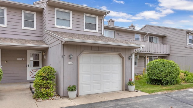 3515 Willow Cir, Sheboygan, WI 53083 - view of front of house with an attached garage, a shingled roof, and driveway