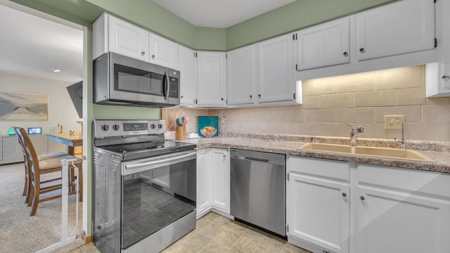 3515 Willow Cir, Sheboygan, WI 53083 - kitchen featuring appliances with stainless steel finishes, white cabinetry, and backsplash