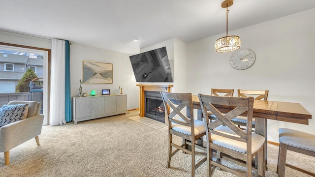3515 Willow Cir, Sheboygan, WI 53083 - carpeted dining room featuring a chandelier and a fireplace with flush hearth