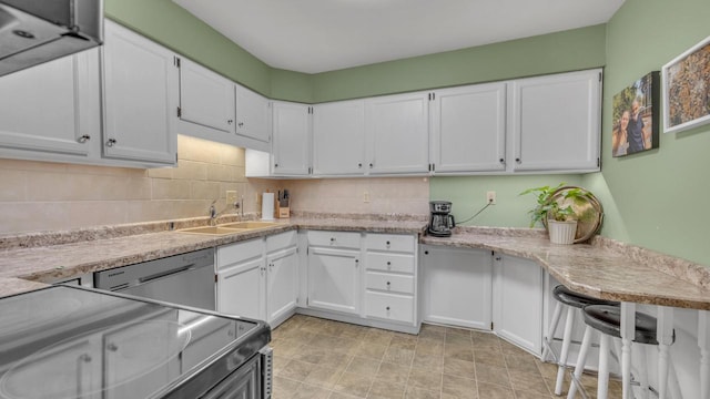 3515 Willow Cir, Sheboygan, WI 53083 - kitchen featuring stainless steel dishwasher, white cabinets, light countertops, and backsplash