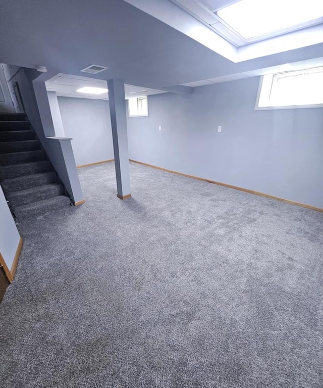 basement featuring carpet flooring and stairs