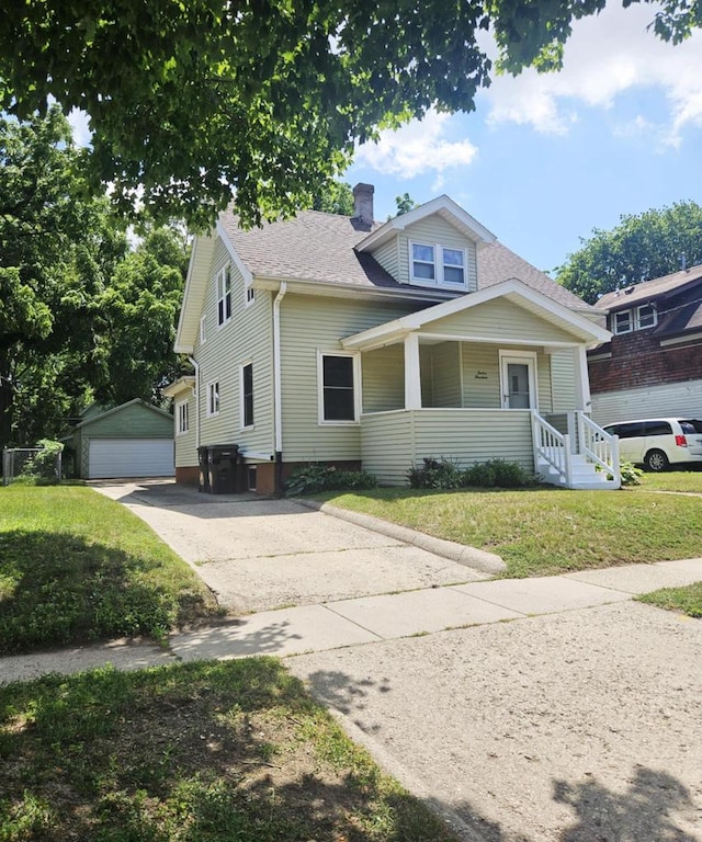 bungalow with covered porch, a front lawn, a chimney, an outdoor structure, and a detached garage