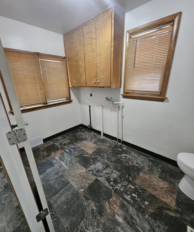 laundry room with hookup for an electric dryer and baseboards