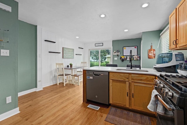 1012 Grove St, Oshkosh, WI 54901 - kitchen featuring stainless steel dishwasher, a peninsula, light wood-type flooring, gas stove, and recessed lighting