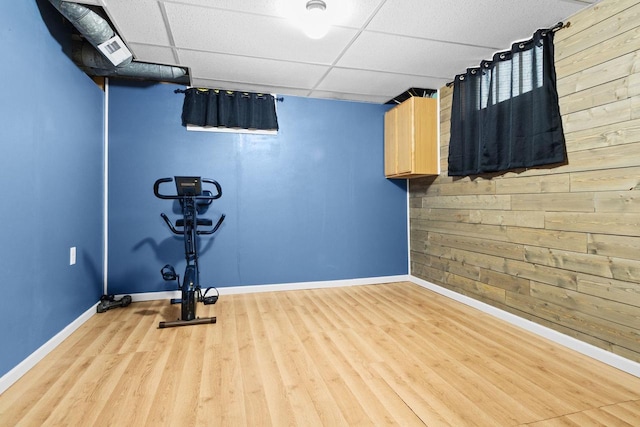 1012 Grove St, Oshkosh, WI 54901 - workout area featuring wooden walls, a drop ceiling, and wood finished floors