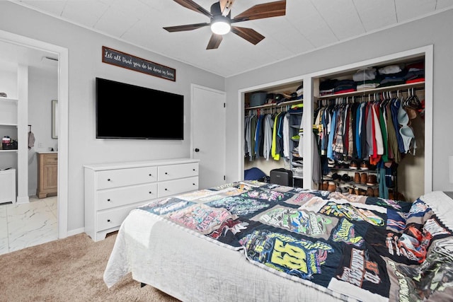 1012 Grove St, Oshkosh, WI 54901 - bedroom featuring multiple closets, marble finish floors, ensuite bath, and a ceiling fan