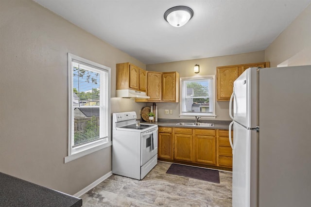 308 Van St, Neenah, WI 54956 - kitchen with white appliances, under cabinet range hood, and brown cabinets