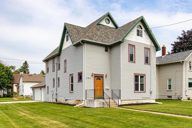524 W New York Ave, Oshkosh, WI 54901 - victorian house with a front lawn, a garage, and a shingled roof