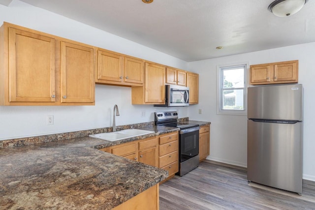 524 W New York Ave, Oshkosh, WI 54901 - kitchen with appliances with stainless steel finishes and light wood-style flooring