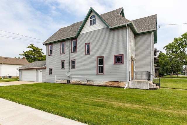 524 W New York Ave, Oshkosh, WI 54901 - view of property exterior with a shingled roof, a yard, and a garage