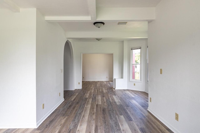 524 W New York Ave, Oshkosh, WI 54901 - spare room featuring arched walkways, dark wood-style floors, and beam ceiling