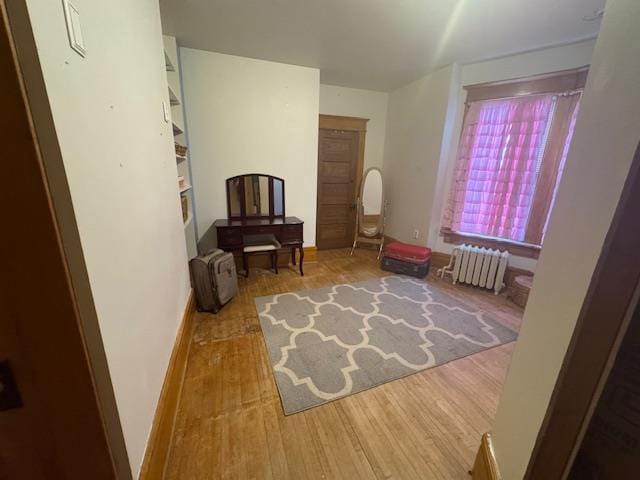 1133 Algoma Blvd, Oshkosh, WI 54901 - sitting room with radiator and wood finished floors