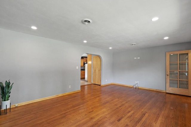 204 Panther Trl, Monona, WI 53716 - spare room featuring arched walkways, recessed lighting, and wood finished floors