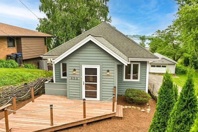 456 W Wisconsin Ave, Pewaukee, WI 53072 - back of house featuring a deck, a shingled roof, and a garage