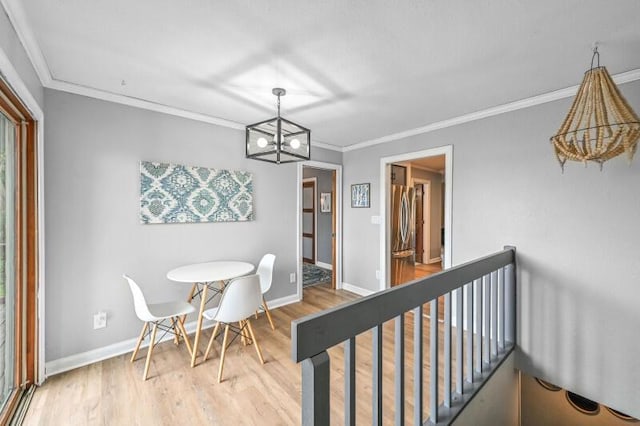 456 W Wisconsin Ave, Pewaukee, WI 53072 - dining area featuring a chandelier, light wood-type flooring, and crown molding