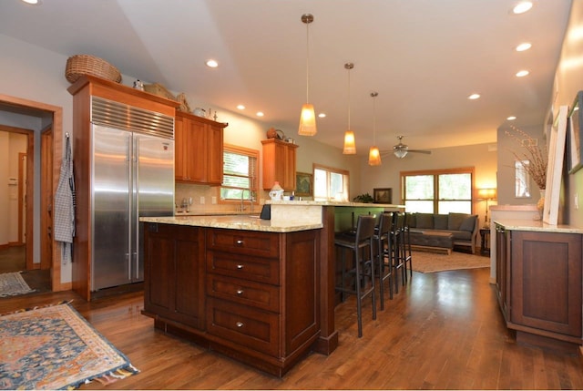 6833 Phil Lewis Way, Middleton, WI 53562 - kitchen with built in fridge, healthy amount of natural light, a breakfast bar area, a ceiling fan, and recessed lighting