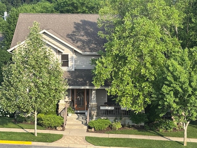 6833 Phil Lewis Way, Middleton, WI 53562 - view of property hidden behind natural elements featuring covered porch and roof with shingles