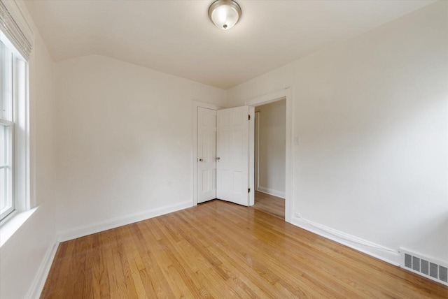 5825 N Bay Ridge Ave, Whitefish Bay, WI 53217 - empty room with light wood-style floors and lofted ceiling