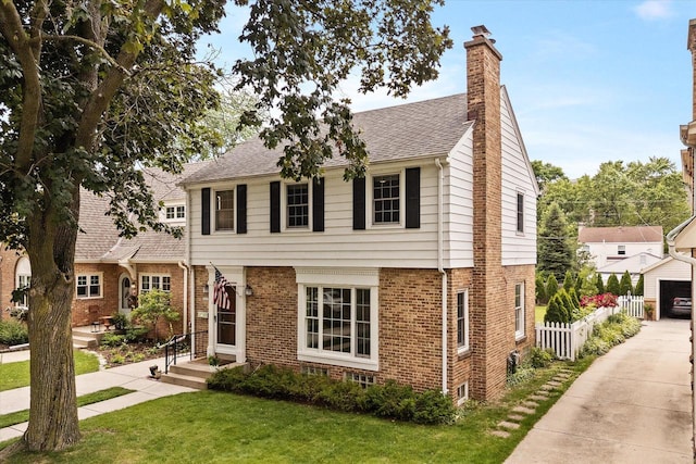 5825 N Bay Ridge Ave, Whitefish Bay, WI 53217 - colonial house with a chimney, brick siding, and a shingled roof