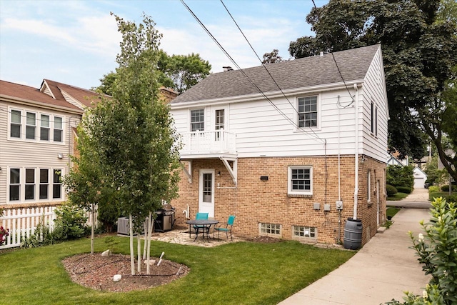 5825 N Bay Ridge Ave, Whitefish Bay, WI 53217 - rear view of house featuring a yard, brick siding, a balcony, and a patio area
