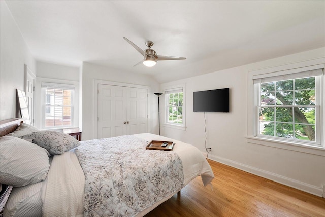 5825 N Bay Ridge Ave, Whitefish Bay, WI 53217 - bedroom featuring multiple windows, light wood finished floors, a closet, and ceiling fan