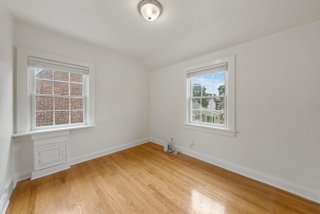 5825 N Bay Ridge Ave, Whitefish Bay, WI 53217 - empty room with light wood finished floors and vaulted ceiling