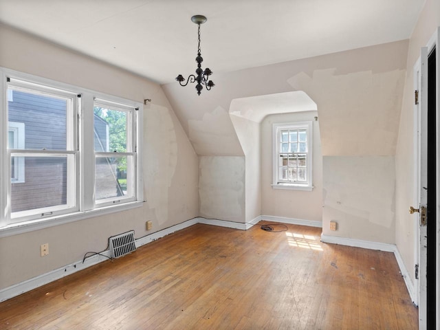 4134 N 46th St, Milwaukee, WI 53216 - additional living space with wood-type flooring, vaulted ceiling, and a chandelier