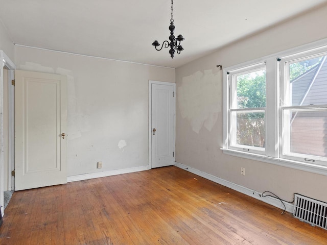 4134 N 46th St, Milwaukee, WI 53216 - empty room with hardwood / wood-style floors and a chandelier