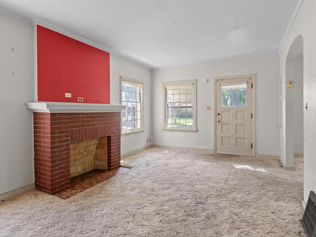 4134 N 46th St, Milwaukee, WI 53216 - unfurnished living room featuring crown molding, a brick fireplace, arched walkways, and carpet