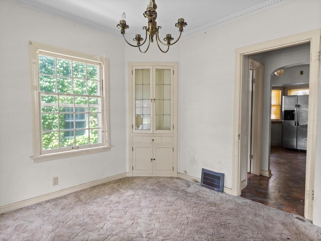 4134 N 46th St, Milwaukee, WI 53216 - spare room featuring a chandelier, arched walkways, crown molding, and carpet