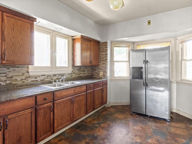 4134 N 46th St, Milwaukee, WI 53216 - kitchen with stainless steel fridge, dark countertops, healthy amount of natural light, and brown cabinets