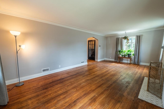 7550 26th Ave, Kenosha, WI 53143 - unfurnished living room with arched walkways, wood finished floors, and crown molding