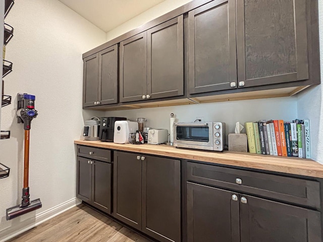 1601 Sauk Trl, Waukesha, WI 53189 - bar with light wood-style flooring and stainless steel microwave