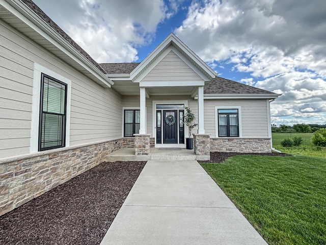 1601 Sauk Trl, Waukesha, WI 53189 - doorway to property with stone siding, a yard, and roof with shingles
