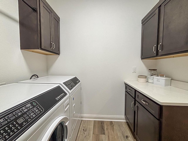 1601 Sauk Trl, Waukesha, WI 53189 - laundry room featuring cabinet space, separate washer and dryer, and light wood-style floors