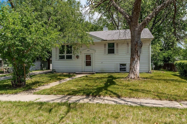 2043 Linway Dr, Beloit, WI 53511 - view of front of home featuring a front lawn, a chimney, and roof with shingles