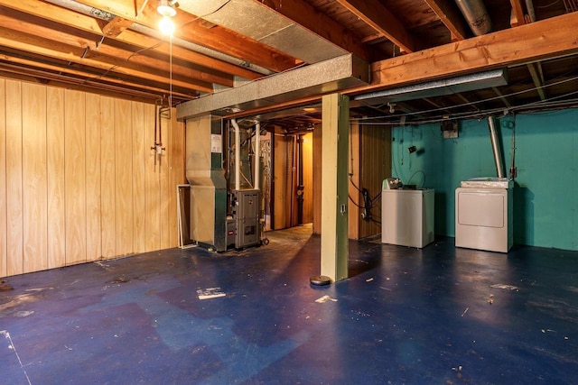 2043 Linway Dr, Beloit, WI 53511 - unfinished basement featuring washing machine and clothes dryer, heating unit, and wood walls