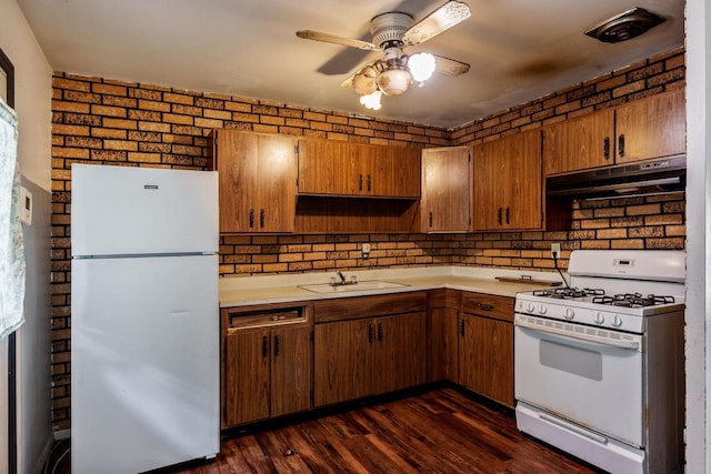 2043 Linway Dr, Beloit, WI 53511 - kitchen with white appliances, under cabinet range hood, light countertops, ceiling fan, and dark wood-style flooring