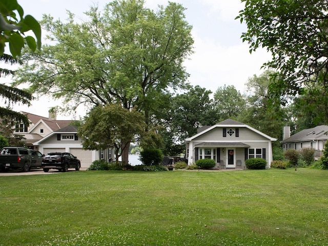N65W35097 Rd J, Oconomowoc, WI 53066 - view of front of house featuring a front yard, a garage, and a porch