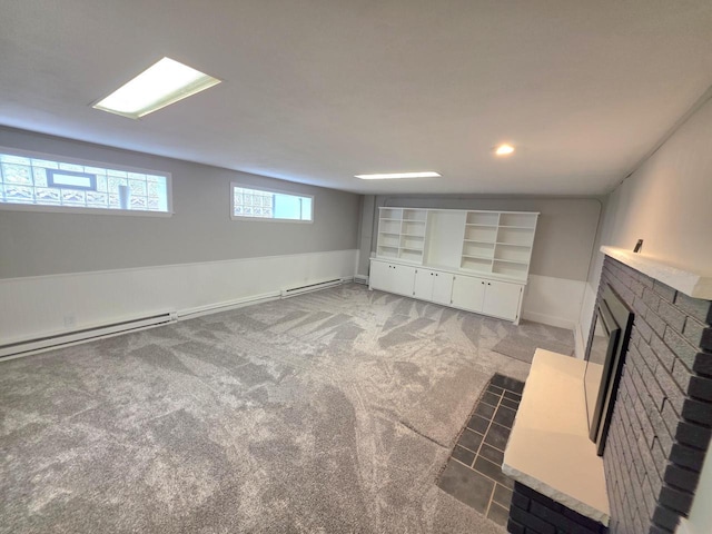 4643 N 108th St, Wauwatosa, WI 53225 - basement with a baseboard heating unit, a brick fireplace, and light carpet